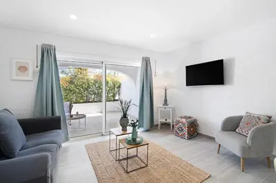 a living room with two couches and a tv at Apartamento Acácia in Vale do Lobo