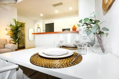a table with plates and glasses on a kitchen counter at Watermelon Sugar Apartment in Faro