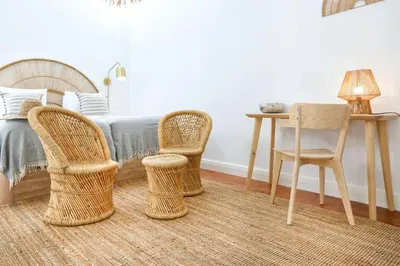 a bedroom with a bed and two chairs and a table at Under the moon in Faro