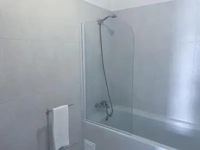a bathroom with a shower with a glass door at Beautiful apartment set in the heart of Quinta - Newly Refurbished in Almancil