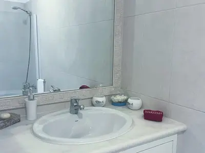 a bathroom with a sink and a mirror at Beautiful apartment set in the heart of Quinta - Newly Refurbished in Almancil