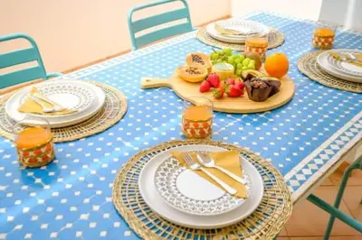 a blue table with plates of food on it at Apartment Esta - Tennis court and pool in Albufeira