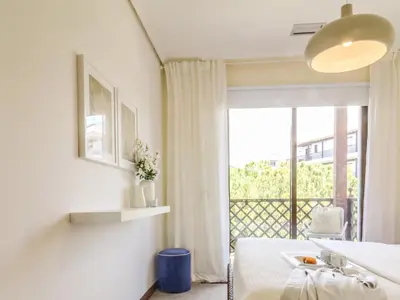 a white room with a bed and a window at Falésia's Harmony -5min to the beach by LovelyStay in Albufeira