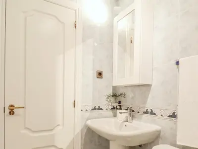 a white bathroom with a sink and a mirror at Falésia's Harmony -5min to the beach by LovelyStay in Albufeira