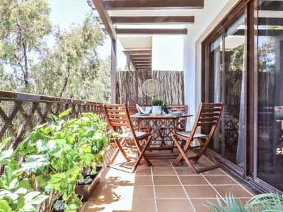 a patio with a table and chairs on a balcony at Falésia's Harmony -5min to the beach by LovelyStay in Albufeira