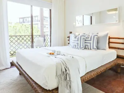 a bedroom with a large bed with a tray on it at Falésia's Harmony -5min to the beach by LovelyStay in Albufeira