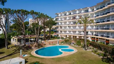 an apartment with a swimming pool in front of a building at Sweet As by LovelyStay in Quarteira
