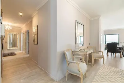 a living room with a table and chairs at Seaview & Sunsets Apartment in Quarteira