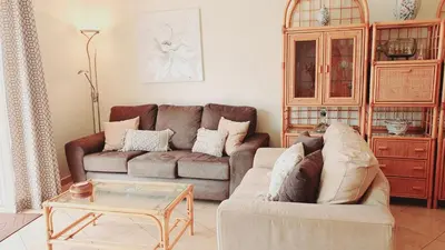 a living room with a couch and a coffee table at Beach Lover's Paradise: 3BR 2 min from the Sand in Quarteira
