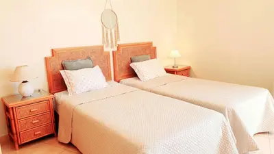 a bedroom with two beds and two night stands at Beach Lover's Paradise: 3BR 2 min from the Sand in Quarteira