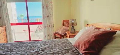 a bedroom with a bed with a view of the ocean at Seaside Serenity: 1BR with Breathtaking Ocean View in Quarteira
