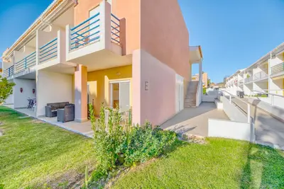 a fence in a yard in front of a building at Casa Serena, Portugal in Guia