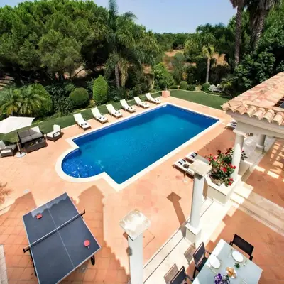 an overhead view of a swimming pool with lounge chairs and a table at Villa Millennium luxury villa relaxing location in Almancil