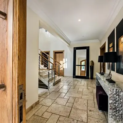 a hallway with a stone floor and a staircase at Villa Millennium luxury villa relaxing location in Almancil