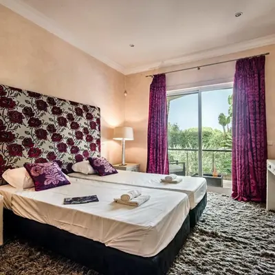 a bedroom with a large bed with a large window at Villa Millennium luxury villa relaxing location in Almancil