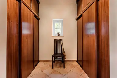 a hallway with a chair and a window at Villa Zarana fantastic house in Salinas in Faro