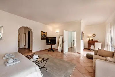 a living room with a bed and a couch and a television at Villa Zarana fantastic house in Salinas in Faro