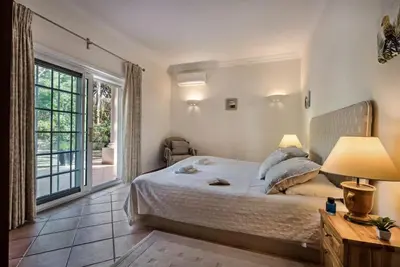 a bedroom with a large bed and a window at Villa Zarana fantastic house in Salinas in Faro