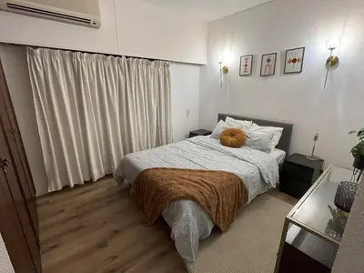 a bedroom with a bed with a brown blanket at Apartamento Diago in Albufeira