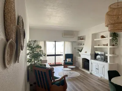 a living room with a couch and a fireplace at Apartamento Diago in Albufeira