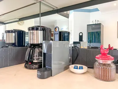 a kitchen with a coffee maker on a counter at Lovely Apartment in Albufeira 2BD 250m Beach Ocean view and AC Wi-Fi Pool in Albufeira
