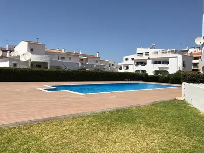 a swimming pool in front of some buildings at Cozy apartment near Oura Beach in Albufeira