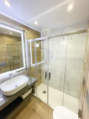 a bathroom with a sink and a shower at So Sweet Center of Faro Flat in Faro