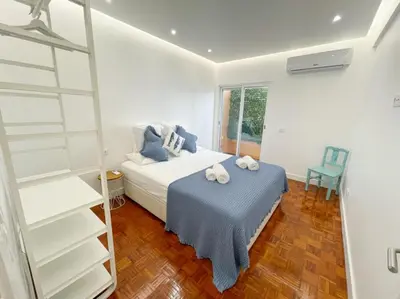 a bedroom with a bed and a book shelf at So Sweet Center of Faro Flat in Faro