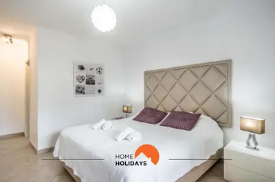 a bedroom with a large white bed in a room at #120 T3 Espaçoso em Albufeira by Home Holidays in Albufeira