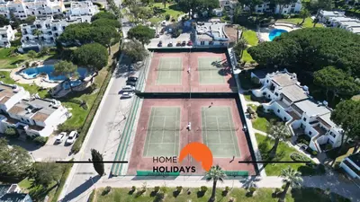 an aerial view of a house with two tennis courts at #120 T3 Espaçoso em Albufeira by Home Holidays in Albufeira