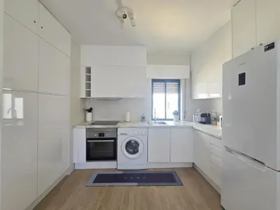 a bedroom with a large bed with blue pillows at Modern Beach Apartment - Avenida Mar 1 - 150 mts da praia in Quarteira