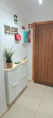 a kitchen with a door and a counter with a plant at T1, proche plage et commerces in Quarteira