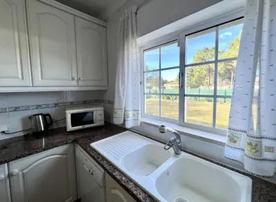 a kitchen with a sink and a window at Vila Caravela - Private Pool by HD Properties in Vilamoura