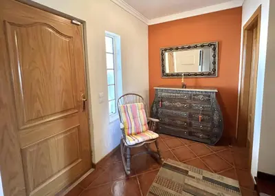 a room with a dresser and a chair and a mirror at Vila Caravela - Private Pool by HD Properties in Vilamoura