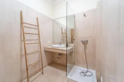 a bathroom with a sink and a glass shower at Villa Gale Grande - bright airy property with a private pool in Albufeira