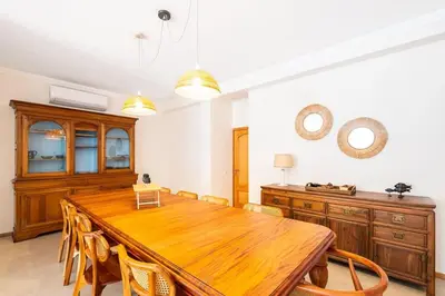 a dining room with a wooden table and chairs at Villa Gale Grande - bright airy property with a private pool in Albufeira