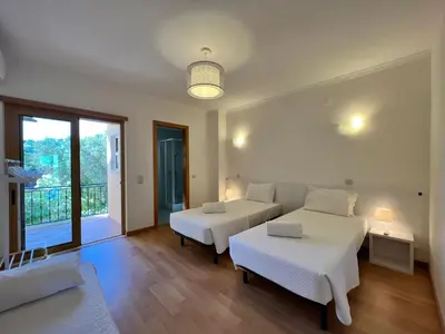 a bedroom with two beds and a balcony at Apartment Filipa III - Beachfront with Jacuzzi in Albufeira