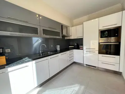 a kitchen with white cabinets and stainless steel appliances at Apartment Filipa III - Beachfront with Jacuzzi in Albufeira