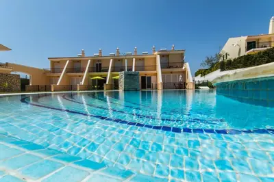 a swimming pool in front of a building at Apartment Filipa III - Beachfront with Jacuzzi in Albufeira