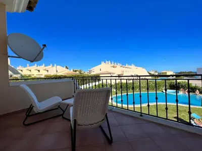 a balcony with a view of a swimming pool at Apartment Filipa III - Beachfront with Jacuzzi in Albufeira