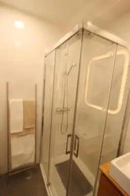 a shower with a glass door in a bathroom at Downtown Villa in Faro