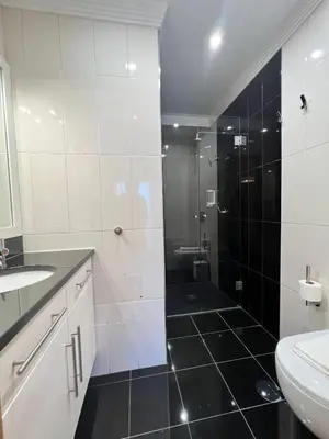 a bathroom with a shower and a toilet and a sink at Villa Pedra Luxe - Spacious modern villa in Albufeira