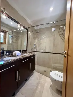 a bathroom with a toilet and a glass shower at Villa Pedra Luxe - Spacious modern villa in Albufeira