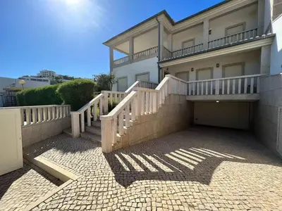 a house with a balcony and a driveway at Villa Pedra Luxe - Spacious modern villa in Albufeira