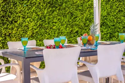 a wooden table with chairs and drinks on it at Villa Adaro - Large Luxury close to marina in Albufeira