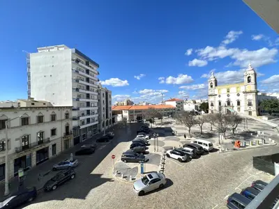 a city street with cars parked in a parking lot at Vista by the Nest - City Center HD PROPERTIES in Faro