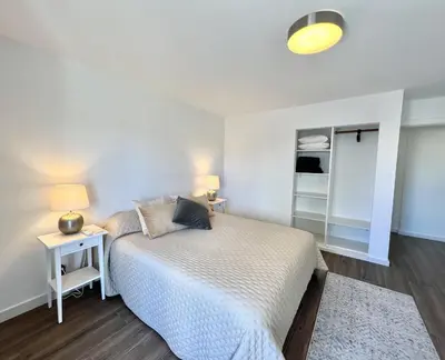 a bedroom with a bed and a night stand with a lamp at Vista by the Nest - City Center HD PROPERTIES in Faro