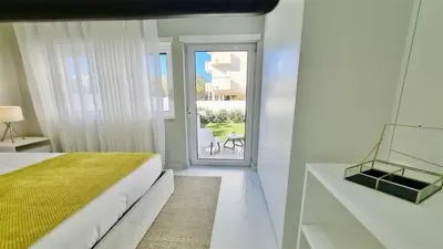 a bedroom with a bed and a door to a patio at Marina Retreat - CleverDetails, for 2 adults and 2 children, Jacuzzi, near the Marina and the beach in Vilamoura