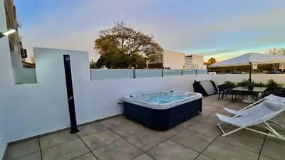 a hot tub sitting on top of a patio at Marina Retreat - CleverDetails, for 2 adults and 2 children, Jacuzzi, near the Marina and the beach in Vilamoura