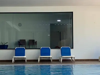 three blue chairs sitting next to a swimming pool at Sunset Bliss in Albufeira - Short walk to Oldtown in Albufeira